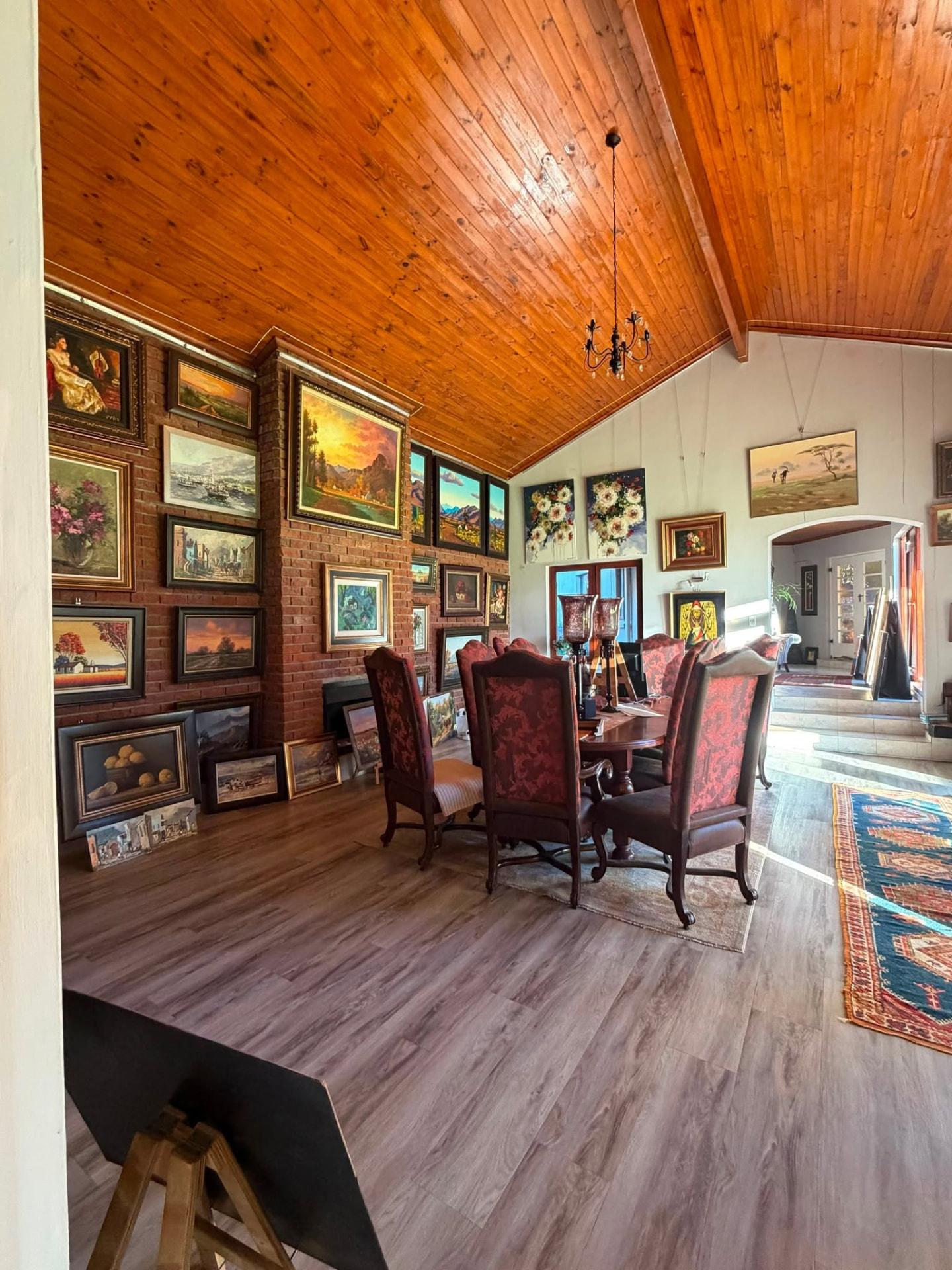 Framed South African paintings stacked and hung together at Kunssinnig Gallery